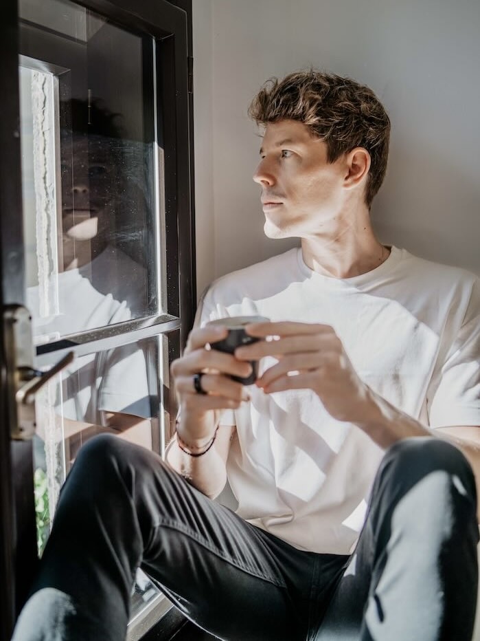 Ben Pages looking at a window